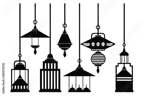 Different styles of black vintage pendant lamps hang in a row on a white backdrop