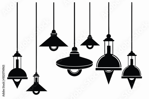 Several distinct black pendant lights hang elegantly against a bright white background creating contrast