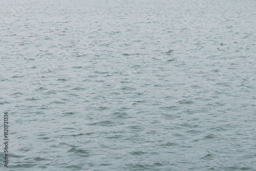 the surface of the water with ripples on an autumn day