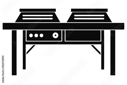 A black solid professional double waffle maker sits atop a dark table