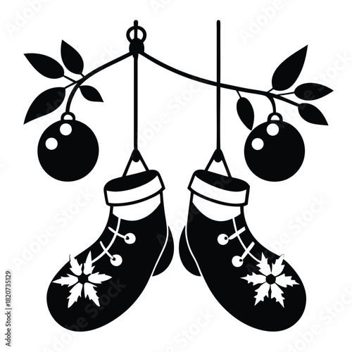 Silhouette shows Christmas stockings with snowflake hanging from branches with holiday ornaments