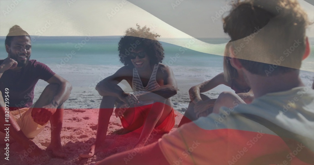 Naklejka premium Chatting five adults sitting on sand by ocean, with sunglasses, casual beachwear and flag overlay