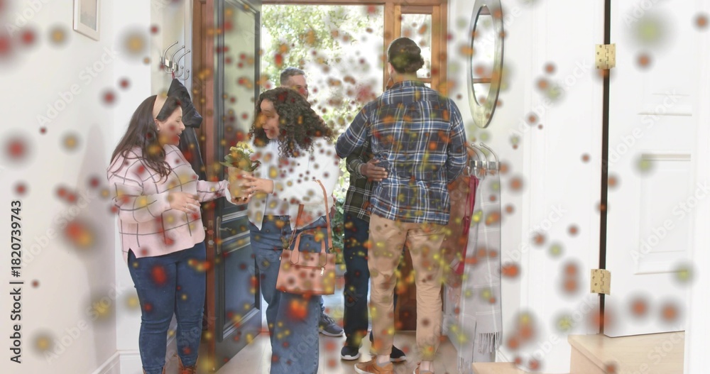 Fototapeta premium Greeting six adults embracing and exchanging bouquet in home entryway, handbag, pink checked top