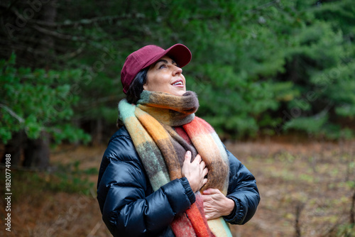 Relaxed woman breathing fresh air in the autumn mountain  and making breathing exercises 