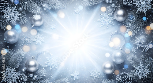 Festive Christmas background with ornaments, pine branches, snowflakes, and bright light.