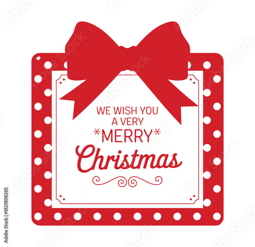 A bright red Christmas gift tag adorned with a large bow and the festive greeting "We Wish You A Very Merry Christmas" is ready to be attached to a present.