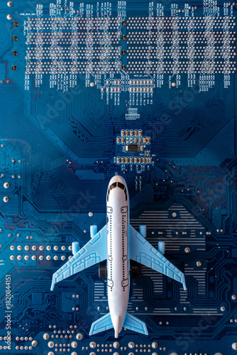 Toy plane on electronic computer circuit board hardware technology. Motherboard digital chip. Computer components. Top view. Copy space.