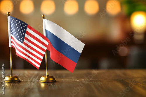 United States USA and Russia small desk flags on wooden table - diplomatic relations concept with copy space