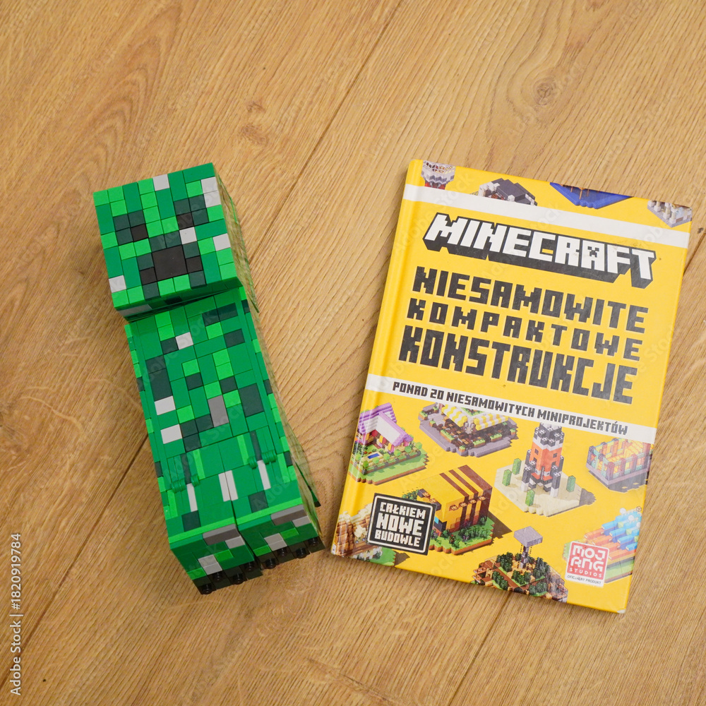Fototapeta premium Minecraft Creeper figure and book on a wooden surface