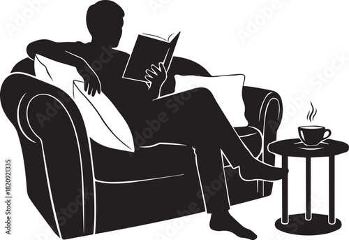 Relaxing silhouette of man reading book in armchair with cup of coffee