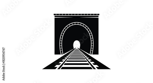 Railway tracks leading into a dark tunnel entrance silhouette
