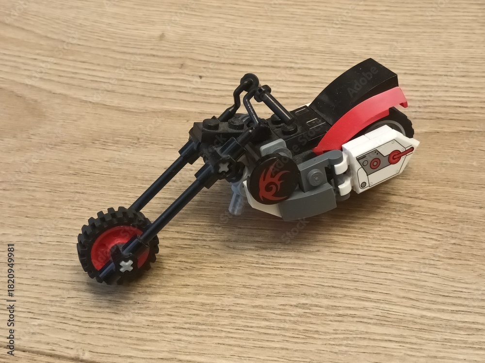 Naklejka premium LEGO® Motorcycle A Cool Red and Black Chopper Building Toy on Wooden Surface