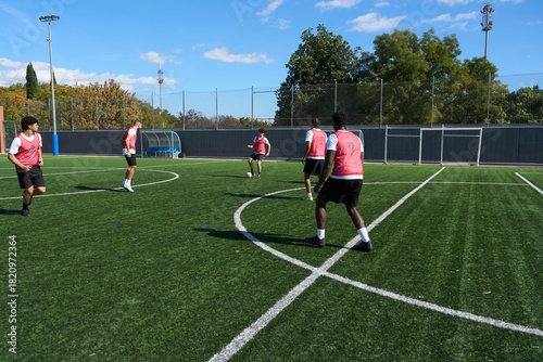 Fotografie Men training in soccer with football on pitch