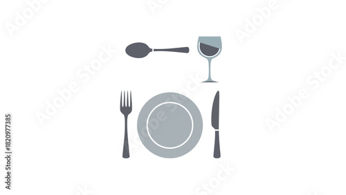 A place setting with a fork plate knife spoon and wine glass