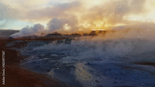 Wallpaper Mural Drone shot over Iceland’s Hverir geothermal fields, revealing dramatic steam vents, colorful sulfur textures, and raw volcanic energy in a surreal otherworldly landscape. Torontodigital.ca