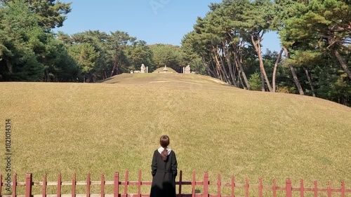 Woman Looking Up at the Royal Burial Mound (Neung) at Taereung (Joseon Royal Tomb) in Seoul

