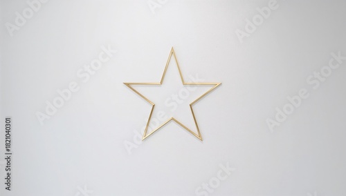 Hanging gold metal five-point star outline centered on smooth light gray wall, showing faint shadow