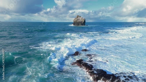 Huge power ocean wave crashing over volcanic cliffs. Aerial view of stormy ocean surf splashing on the coast in Iceland