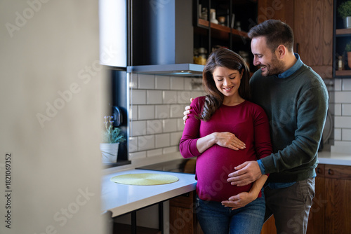 Εκτύπωση καμβά Man in love hugs his pregnant wife, they are waiting together for the baby's arrival