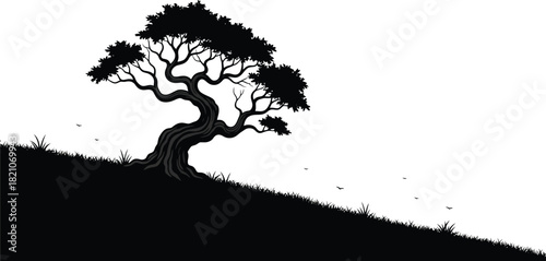 A solitary silhouetted tree gracefully stands on a gently sloping hill