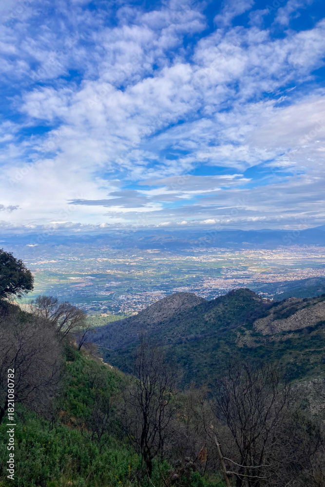 Obraz premium Hiking on trail along abandoned open-pit mine and burnt trees near Mijas, Spain 