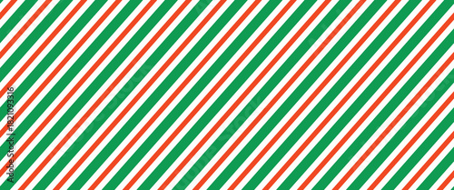 Christmas seamless pattern. Red and green diagonal stripes background. Candy cane repeating decoration wallpaper. Winter holiday lines backdrop. Xmas peppermint present wrapping print design. Vector