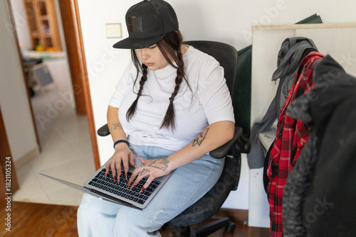 Young woman concentrating, working on laptop at home