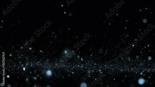 A dynamic field of glowing blue and white particles against a black background suggesting stardust or bokeh effects.