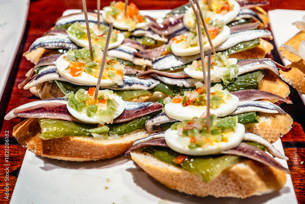 Fototapeta premium Plate with traditional Spanish snacks called pinchos in San Sebastian city also called Donostia in Gipuzkoa region of Spain