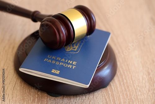 Judge mallet and ukrainian passport on brown background. Passport Of Ukraine. Obtain citizenship