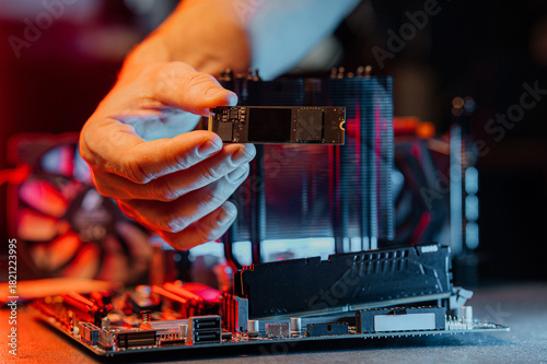 SSD M2 disk close up with selective focus on the interface. On dark background with reflection