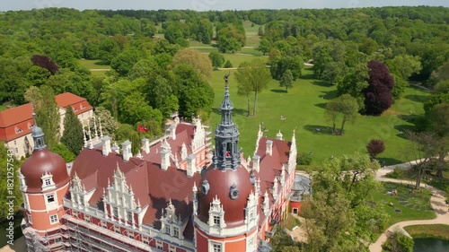 Aerial view of Muskau Castle in Fürst Pückler Park, Bad Muskau, surrounded by wide green areas, trees, and a picturesque landscape park.