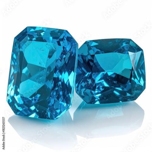 Two vibrant, deep-blue gemstones, likely synthetic or treated natural stones, showcasing an emerald cut.  High-quality, reflective facets and a brilliant, clear appearance.  Perfect for jewelry