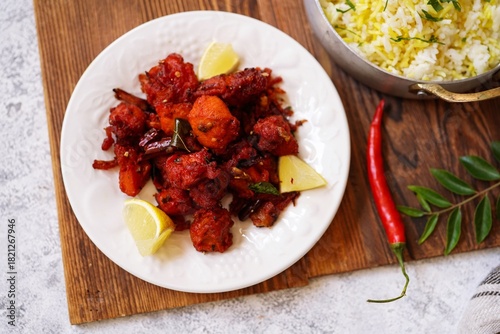 Homemade Chicken 65 - Popular Indian bar ppetizer  served with saffron rice