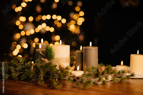 Festive candle spread on wooden table, multiple flames and evergreen garland, warm golden bokeh tree, intimate hosting scene, holiday dinner preparation, elegant seasonal ambiance