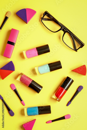 make up set on yellow background top view