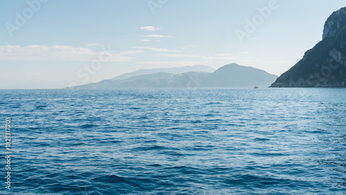 Fototapeta Naklejka Na Ścianę i Meble -  Capri, Italy - 04.29.2025: Seascape from the highest point of the island with a view of the sea and islands. There is haze in the distance.