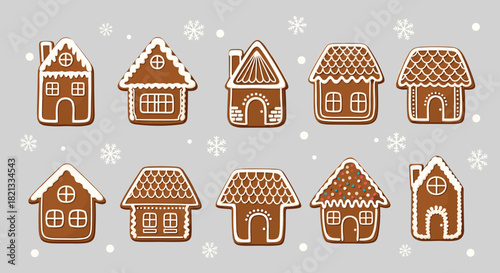 Festive collection of traditional gingerbread houses decorated with white icing and colorful sprinkles on a light snowy background.