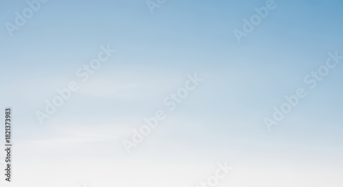 A Serene Gradient of Blue Fading Into a Pure White Sky Backdrop