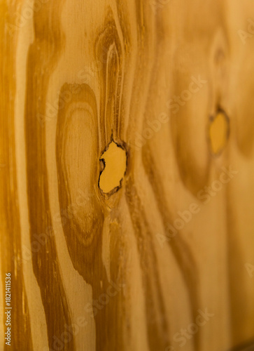 Detailed close-up of a wooden surface showing natural grain patterns. The image highlights the organic texture of wood.