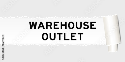 Ripped gray paper background that have word warehouse outlet under torn part