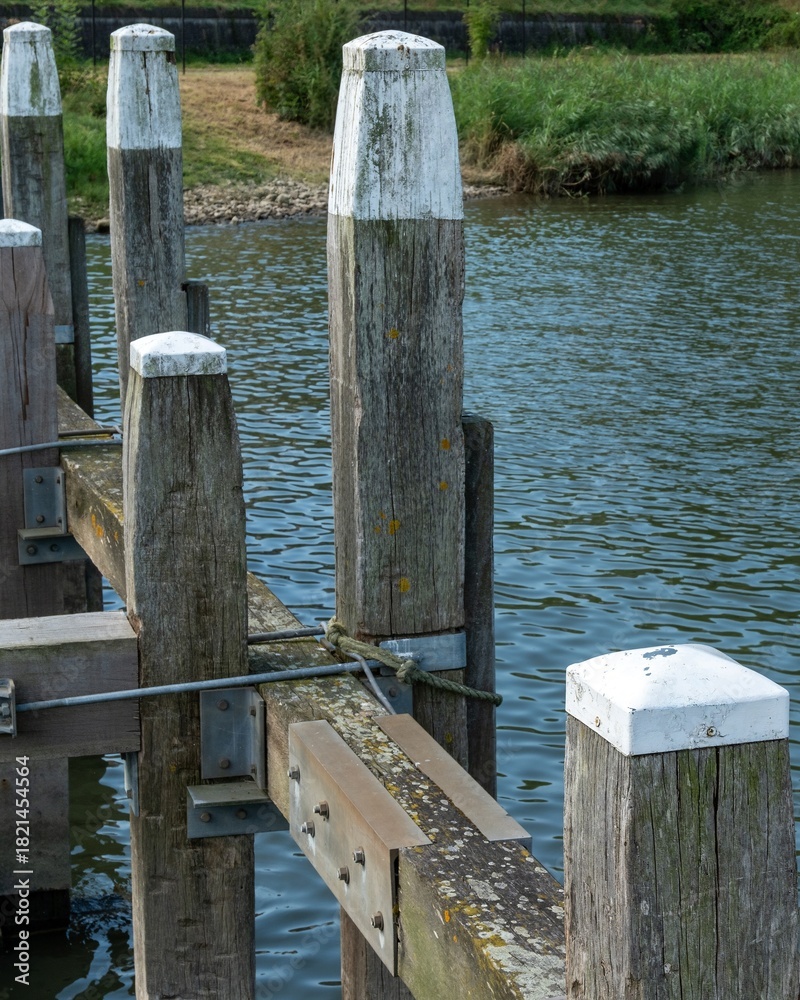 Fototapeta premium large white wooden piles with white head on the pier