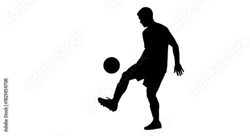 Silhouette of a soccer player juggling a ball with his knee.
