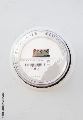 Close-up of digital electric meter on white wall