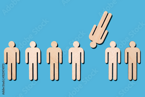 Wooden cutouts of people on blue background