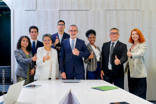 Group of diverse business team trumb up for take a photo to confirm quality of business service in meeting room of office.