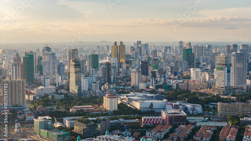 Modern residential areas and office buildings with Tonle Sap river in the background in rapidly developing Phnom Penh city panorama, Cambodia