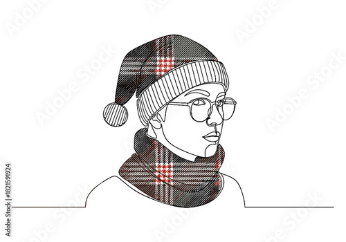 Young woman wearing a knitted hat and scarf with plaid design for Christmas and New Year  