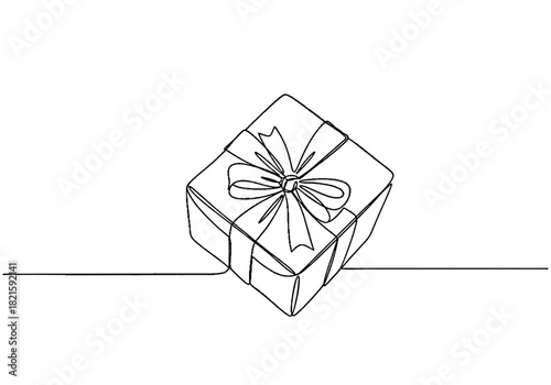 Gift box with ribbon on a plain surface for Christmas and New Year  