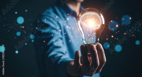 Person holds glowing lightbulb with brain inside against dark backdrop with blue lights. Represents creative thinking, smart solutions, and new ideas. Perfect for innovation and business content.